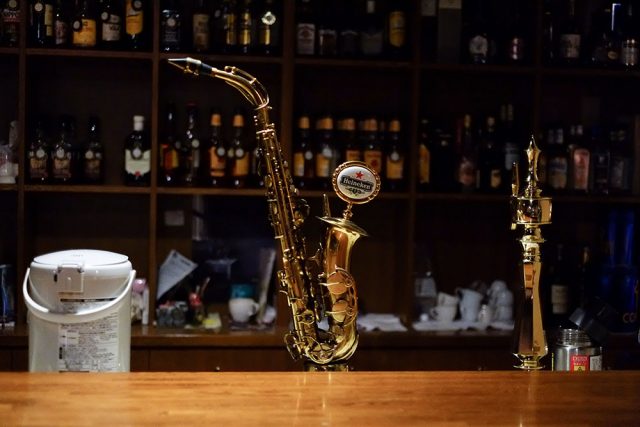 A real alto saxophone turned into a beer server. Neat stuff you only find in jazz bars.